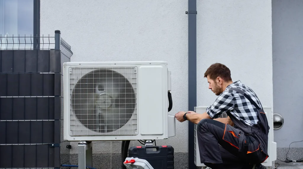 24 Hour Heating and Air technician working on an Air Conditioning unit.
