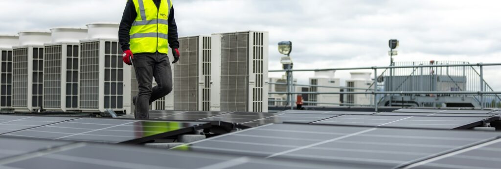 Technician inspecting commercial rooftop HVAC units in Greenville, SC