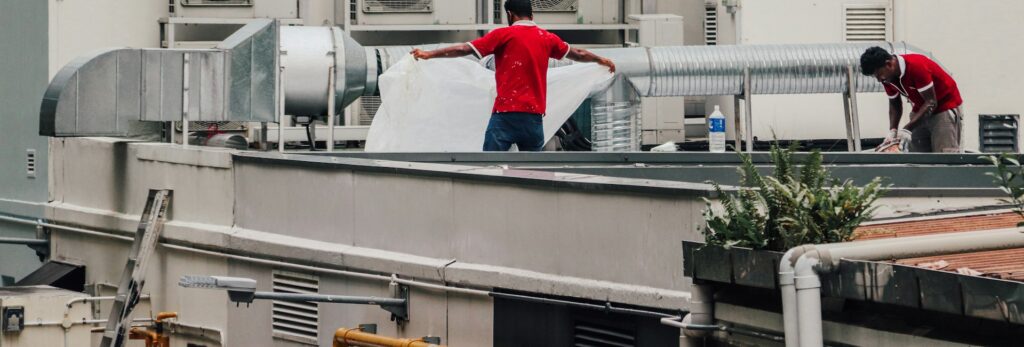 HVAC technicians repairing rooftop air conditioning units in Greenville, SC